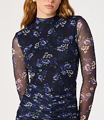 A woman in a dark blue floral mesh top with ruched detailing stands against a plain white background. carousel Product Image 3