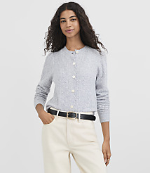 A woman in a light gray cardigan and cream pants stands against a plain gray background. carousel Product Image 1