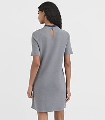A woman in a grey dress with a ruffled collar stands against a plain white background. carousel Product Image 3