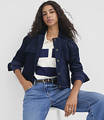 A woman in a navy corduroy jacket and blue jeans poses against a plain white background. carousel Product Image 1