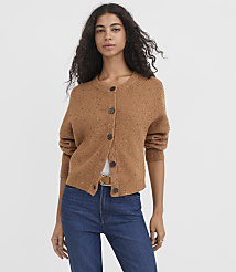 A woman in a brown speckled cardigan and blue jeans stands against a plain white background. carousel Product Image 2