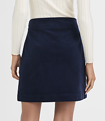 A navy blue corduroy skirt is worn by a person with a white ribbed sweater, against a plain white background. carousel Product Image 3