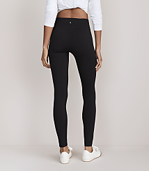 A person wearing black leggings and white sneakers stands against a plain white background. carousel Product Image 3