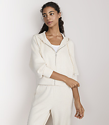A woman in a cream-colored loungewear set stands against a plain white background. carousel Product Image 2