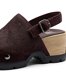 A close-up of a burgundy, furry clog with a wooden sole and a black rubber sole is set against a plain white background. carousel Product Image 6