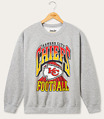 A gray Kansas City Chiefs football sweatshirt with a vintage design hangs on a wooden hanger against a plain white background. carousel Product Image 1