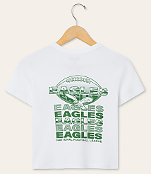 A white t-shirt with a green graphic of an eagle and "EAGLES" repeated multiple times is displayed on a wooden hanger against a plain white background. carousel Product Image 1