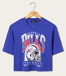 A royal blue cropped t-shirt with a vintage Buffalo Bills graphic hangs on a wooden hanger against a plain white background. carousel Product Image 1
