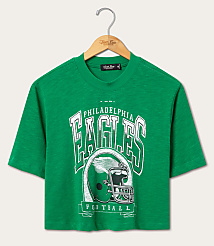 A green Philadelphia Eagles football t-shirt hangs on a wooden hanger against a plain white background. carousel Product Image 1