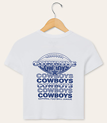 A white t-shirt with a Dallas Cowboys logo and repeated "Cowboys" text is displayed on a hanger against a plain white background. carousel Product Image 1