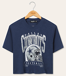 A navy blue Dallas Cowboys t-shirt with a graphic of a helmet and team name hangs on a wooden hanger against a plain beige background. carousel Product Image 1