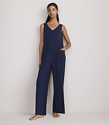 A woman in a navy blue jumpsuit stands against a plain white background. carousel Product Image 1
