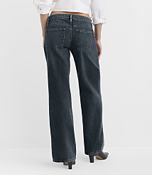 A person wearing dark wash, wide-leg jeans and black heels stands against a plain white background. carousel Product Image 2