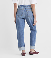 A person wearing cuffed denim jeans and burgundy loafers stands against a plain white background. carousel Product Image 3