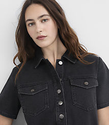 A woman with long brown hair wears a dark denim shirt with two chest pockets, set against a plain gray background. carousel Product Image 4