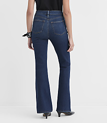 A person wearing dark wash flare jeans and black heels stands against a plain white background. carousel Product Image 2