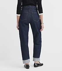A person wearing dark wash cuffed jeans and black loafers stands against a plain white background. carousel Product Image 3