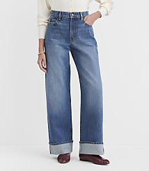 A person stands in the foreground wearing wide-leg cuffed jeans and burgundy loafers, against a plain white background. carousel Product Image 2