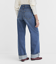 A person wearing wide-leg jeans with cuffed hems and red shoes stands against a plain white background. carousel Product Image 3