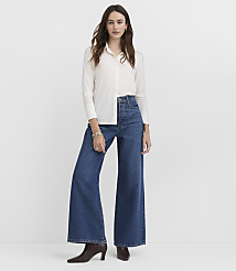 A woman in a white button-down shirt and wide-leg jeans stands against a plain white background. carousel Product Image 1