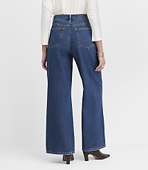 A person wearing wide-leg blue jeans and a white top stands against a plain white background. carousel Product Image 3