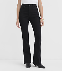 A person wearing black flare jeans and black heeled boots stands against a plain white background. carousel Product Image 2