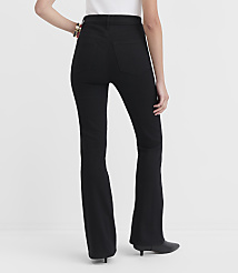 A person wearing black flare jeans and black heeled boots stands against a plain white background. carousel Product Image 3
