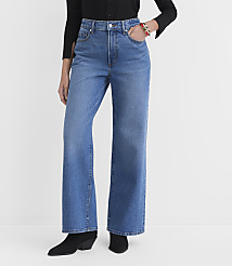 A person wearing wide-leg blue jeans and black boots stands against a plain white background. carousel Product Image 2