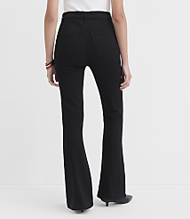 A person wearing black flare jeans stands against a plain white background. carousel Product Image 2