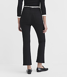 A person wearing black flared jeans and black loafers stands against a plain white background. carousel Product Image 2