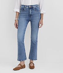 A person wearing flared blue jeans and brown flats stands against a plain white background. carousel Product Image 2