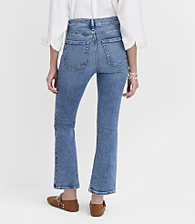 A person wearing flared blue jeans and brown flats stands against a plain white background. carousel Product Image 3