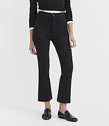 A person wearing black flared jeans and black loafers stands against a plain white background. carousel Product Image 2