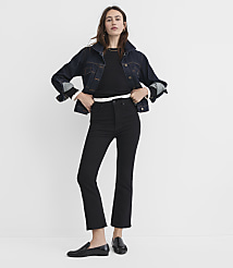 A woman in a denim jacket and black jeans stands against a plain white background. carousel Product Image 1