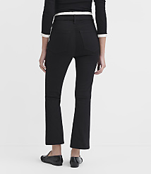 A person wearing black flared jeans and black loafers stands against a plain white background. carousel Product Image 3
