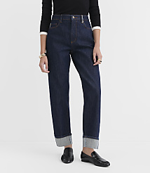 A person stands in dark wash cuffed jeans and black loafers against a plain white background. carousel Product Image 1