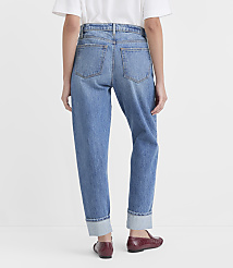 A person wearing cuffed blue jeans and burgundy loafers stands against a plain white background. carousel Product Image 2