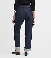 A person wearing dark wash cuffed jeans and black loafers stands against a plain white background. carousel Product Image 2