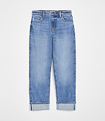 A pair of cuffed light-wash denim jeans are displayed against a plain white background. carousel Product Image 4