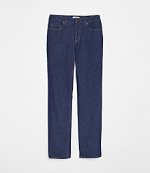 A pair of dark wash denim jeans with orange stitching lies flat against a plain white background. carousel Product Image 4