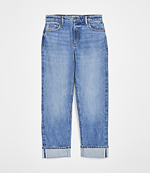 A pair of cuffed light-wash denim jeans are displayed against a plain white background. carousel Product Image 3