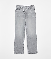 Light gray denim jeans with a unique crossover waistband are displayed against a plain white background. carousel Product Image 3