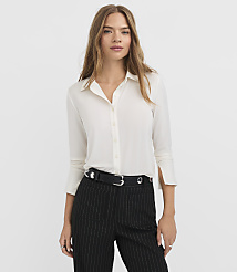 A woman in a white blouse and pinstripe pants stands against a plain white background. carousel Product Image 1