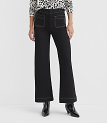 A person stands in black flared pants with white stitching and a leopard print top, against a plain white background. carousel Product Image 2