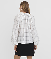 A woman in a white plaid blouse and black skirt stands against a plain white background. carousel Product Image 3