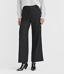 A person stands in black pinstripe wide-leg pants and shiny black boots against a plain white background. carousel Product Image 2