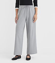 A person stands in light gray wide-leg pants and black flats against a plain white background. carousel Product Image 2
