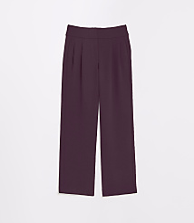 A pair of plum-colored, wide-leg trousers with pleats and pockets are laid flat against a plain white background. carousel Product Image 5