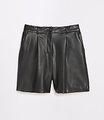 Black faux leather shorts with pleats in the foreground are set against a plain white background. carousel Product Image 5