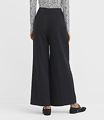 A person wearing wide-leg black pants and a patterned top stands against a plain white background. carousel Product Image 3